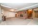 Unfinished basement featuring a brick fireplace, carpet flooring, and access to stairs at 165 Fieldstone Farm Dr, Statesville, NC 28625