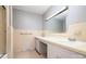 Bathroom featuring beige tiling, double sinks, and a large mirror at 165 Fieldstone Farm Dr, Statesville, NC 28625