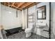 Rustic basement bathroom featuring a clawfoot tub and pedestal sink at 165 Fieldstone Farm Dr, Statesville, NC 28625