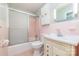 A full bathroom featuring a bathtub and shower combo, light pink tile and a traditional style vanity at 165 Fieldstone Farm Dr, Statesville, NC 28625