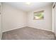 Neutral-colored bedroom with carpet flooring, one window, and baseboard molding at 165 Fieldstone Farm Dr, Statesville, NC 28625