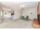 Dining area featuring a classic table set, carpet, and an adjacent brick fireplace at 165 Fieldstone Farm Dr, Statesville, NC 28625