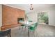 Dining room with access to an outdoor patio, showcasing a brick fireplace at 165 Fieldstone Farm Dr, Statesville, NC 28625