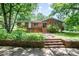 Traditional brick home with a welcoming front porch and landscaped garden at 165 Fieldstone Farm Dr, Statesville, NC 28625