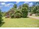 Brick home with detached garage and green grass, highlighting the property's charm at 165 Fieldstone Farm Dr, Statesville, NC 28625