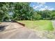 Expansive lawn showcasing the house, lush green landscape with trees and exterior features at 165 Fieldstone Farm Dr, Statesville, NC 28625