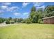 Lush lawn with mature trees, highlighting the home's setting at 165 Fieldstone Farm Dr, Statesville, NC 28625