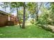 Brick home featuring a well-maintained yard with mature trees and established greenery at 165 Fieldstone Farm Dr, Statesville, NC 28625