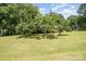 View of the house in a sprawling yard, featuring mature trees that enhance the property's appeal at 165 Fieldstone Farm Dr, Statesville, NC 28625