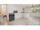 An open kitchen with wood-look flooring, a breakfast bar, and neutral colors at 165 Fieldstone Farm Dr, Statesville, NC 28625