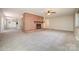 Open-concept living room with brick fireplace, adjacent to the kitchen at 165 Fieldstone Farm Dr, Statesville, NC 28625