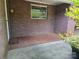 Cozy, covered brick porch featuring classic brickwork flooring, creating an inviting outdoor space at 165 Fieldstone Farm Dr, Statesville, NC 28625
