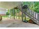 Covered back patio with stairs, basketball hoop, and an outdoor space for recreation and relaxation at 1701 Whitney Ln, Salisbury, NC 28146