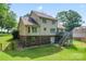 Expansive backyard view featuring a deck, stairs, and partial brick foundation at 1701 Whitney Ln, Salisbury, NC 28146