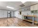 Finished basement featuring stainless steel refrigerator, wood flooring, and a crafting area with natural light at 1701 Whitney Ln, Salisbury, NC 28146