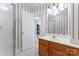 A bathroom with a single sink vanity, tiled floor, and walk-in shower at 1701 Whitney Ln, Salisbury, NC 28146