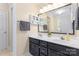 Bathroom featuring a double sink vanity, storage cabinet, and a large framed mirror at 1701 Whitney Ln, Salisbury, NC 28146