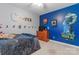 This bedroom has a blue accent wall, wood dresser, and themed decor at 1701 Whitney Ln, Salisbury, NC 28146