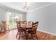 Bright dining room featuring hardwood floors, a chandelier, and abundant natural light at 1701 Whitney Ln, Salisbury, NC 28146