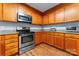 Updated kitchen with modern appliances, granite countertops, and wooden cabinetry at 1701 Whitney Ln, Salisbury, NC 28146