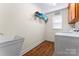 Functional laundry room featuring a utility sink, shelving and a modern washer and dryer unit at 1701 Whitney Ln, Salisbury, NC 28146