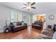 Cozy living room features wood floors and bright windows leading to the kitchen at 1701 Whitney Ln, Salisbury, NC 28146