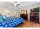 A spacious main bedroom with a trey ceiling, ceiling fan, and wood-look flooring at 1701 Whitney Ln, Salisbury, NC 28146