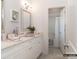 Elegant bathroom with double vanity, marble countertop, white cabinets, and an open view into the shower area at 2008 Thatcher Way, Fort Mill, SC 29715