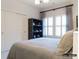 Comfortable bedroom with a bed, built-in shelving, shuttered windows, and ample closet space at 2008 Thatcher Way, Fort Mill, SC 29715