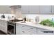 Modern eat-in kitchen featuring granite countertops, backsplash, stainless steel appliances, and hardwood floors at 2008 Thatcher Way, Fort Mill, SC 29715