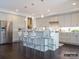 Open concept kitchen with gray cabinets, a long island with barstool seating, and stainless steel appliances at 2008 Thatcher Way, Fort Mill, SC 29715
