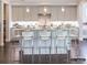 Bright eat-in kitchen features gray cabinets, a white backsplash, stainless steel appliances, and hardwood floors at 2008 Thatcher Way, Fort Mill, SC 29715