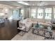 Spacious living room area with many windows, hardwood floors, white couch, and an area rug at 2008 Thatcher Way, Fort Mill, SC 29715
