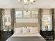 Luxurious main bedroom with tray ceiling, chandelier, soft lighting, and decorative wall panels at 2008 Thatcher Way, Fort Mill, SC 29715