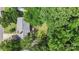 An aerial view shows the house nestled among lush trees, with a spacious backyard and neighborhood surroundings at 2012 Killarney Pl, Charlotte, NC 28262