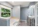 Bathroom with stylish gray plank flooring, a tub, and a vanity with ample counter space at 2012 Killarney Pl, Charlotte, NC 28262