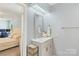 Connected bathroom and bedroom featuring neutral wall colors and white trim throughout at 2012 Killarney Pl, Charlotte, NC 28262