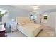 Bright bedroom features a bed, vanity, and ensuite bathroom with a tub, ideal for relaxation at 2012 Killarney Pl, Charlotte, NC 28262