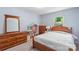 Charming bedroom with wood furniture, a cozy bed, and natural light from the window at 2012 Killarney Pl, Charlotte, NC 28262