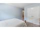View of a bright bedroom with carpeted flooring and an ensuite bathroom entrance at 2012 Killarney Pl, Charlotte, NC 28262