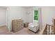 Well-lit Bedroom features a comfortable armchair near a window with natural light at 2012 Killarney Pl, Charlotte, NC 28262