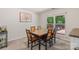 Dining room with a unique wood table, six chairs, and a bright window at 2012 Killarney Pl, Charlotte, NC 28262