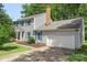 Beautiful two-story home features an attached two-car garage, classic siding, and vibrant blue shutters at 2012 Killarney Pl, Charlotte, NC 28262