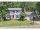 Charming two-story home features a well-manicured lawn, bright blue shutters, and an attached two-car garage at 2012 Killarney Pl, Charlotte, NC 28262