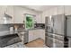 Modern kitchen with stainless steel appliances, granite countertops and gray backsplash, ready to be enjoyed at 2012 Killarney Pl, Charlotte, NC 28262