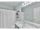This modern bathroom features a marble sink, mirror, toilet, and shower with patterned curtain at 2026 Rosewater Ln, Indian Trail, NC 28079