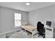 This simple bedroom includes a twin bed with striped bedding and a modern computer desk set at 2026 Rosewater Ln, Indian Trail, NC 28079