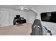 This bonus room features a large office setup with carpet and a modern television at 2026 Rosewater Ln, Indian Trail, NC 28079