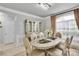 Bright dining area featuring a modern chandelier, designer cabinet, and seating for six at 2026 Rosewater Ln, Indian Trail, NC 28079