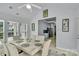 Bright dining room with natural light and a glimpse of the kitchen with blue cabinetry at 2026 Rosewater Ln, Indian Trail, NC 28079